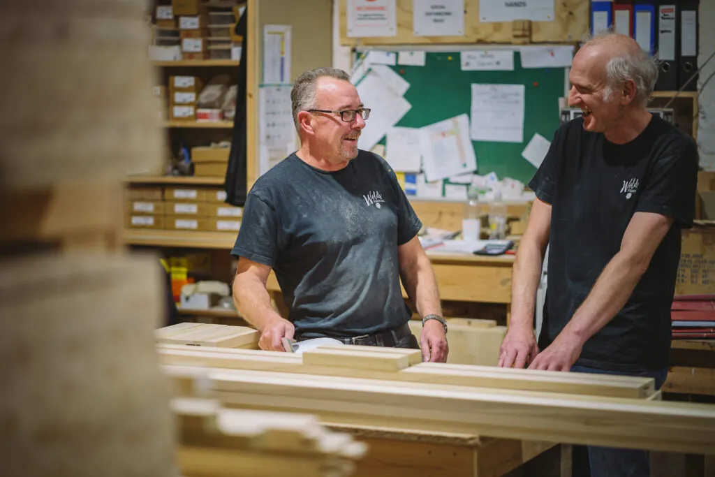 Wolds furniture joiners sat around a workbench